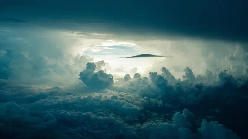 Dark storm clouds with a bright opening of sky