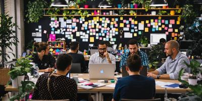 Developers collaborating in a colorful, modern workspace.