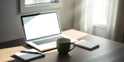 A calm workspace with a laptop and coffee cup.